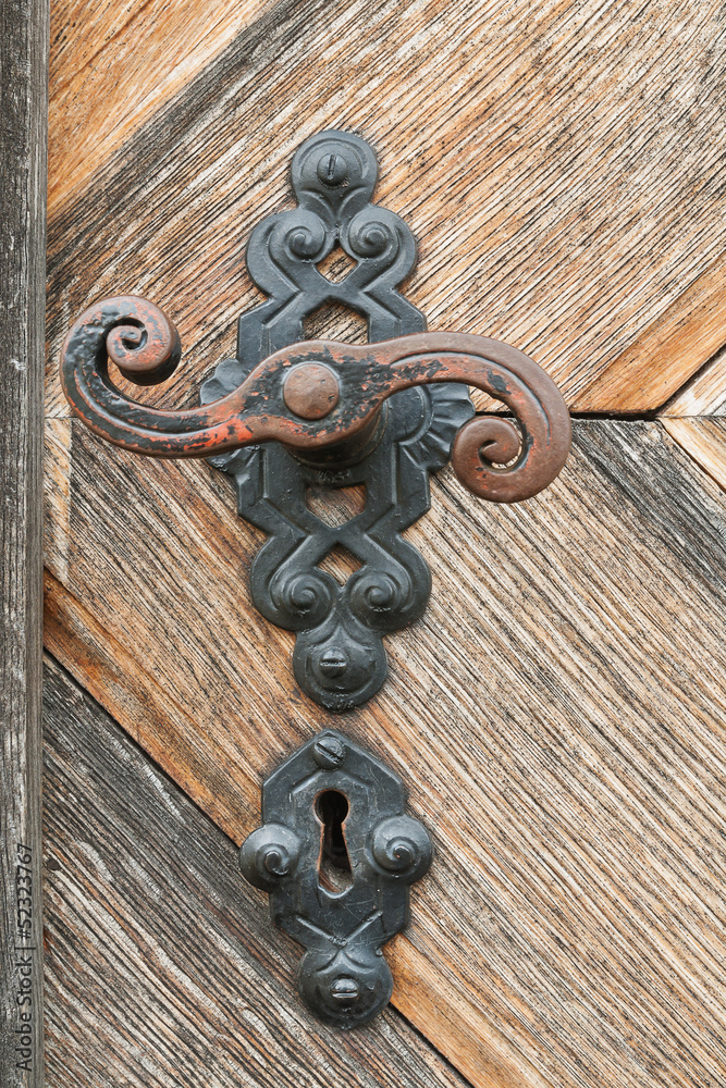 an old wood door with metal handle an old wood door with metal handle