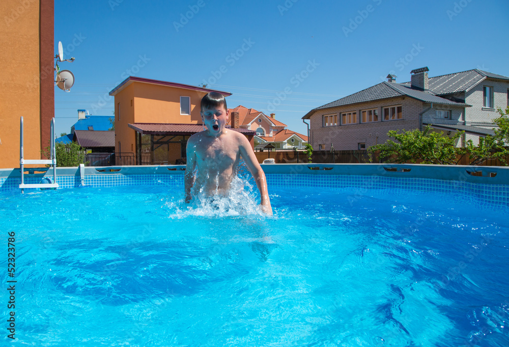 boy jumping in the pool