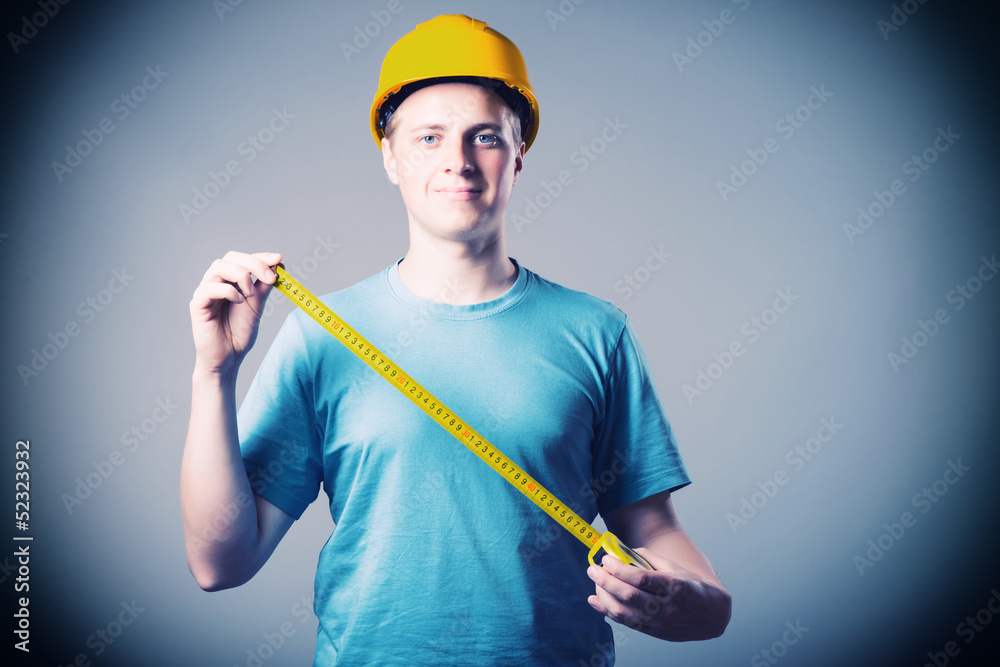 engineer in a helmet uses a tape measure engineer in a helmet uses a tape measure