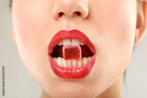 woman sucking cute sweet candy closeup