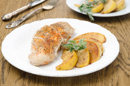 Baked chicken and saute quince with rosemary closeup