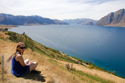 New Zealand woman enjoying the sun and beautiful lakeside view