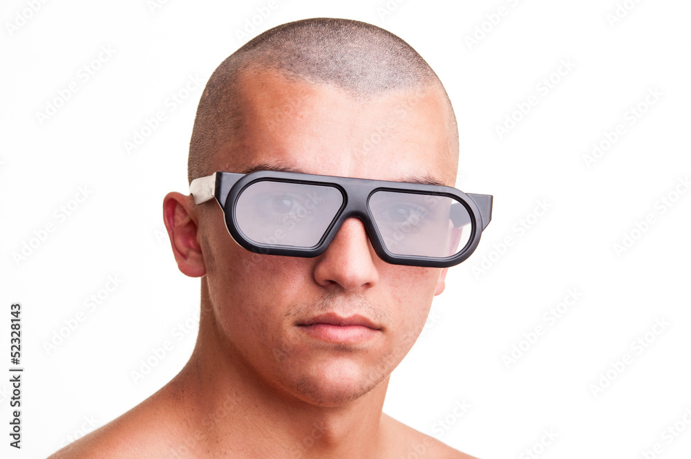 Portrait of a bald young man wearing 3d-glasses over white backg Portrait of a bald young man wearing 3d-glasses over white backg