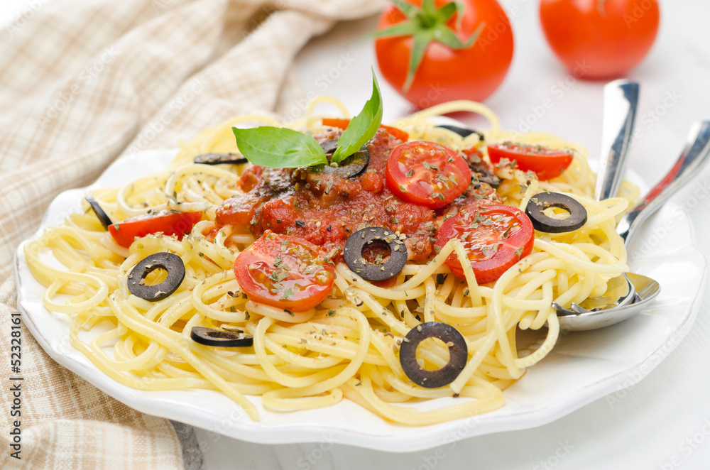 spaghetti with tomato sauce, cherry tomatoes and olives