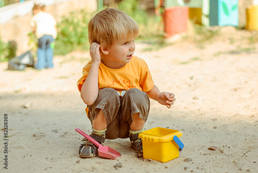Little kids play in the sand box Little kids play in the sand box