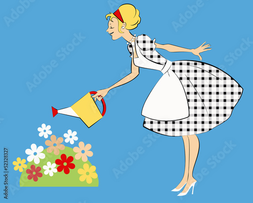 Woman watering flower bed