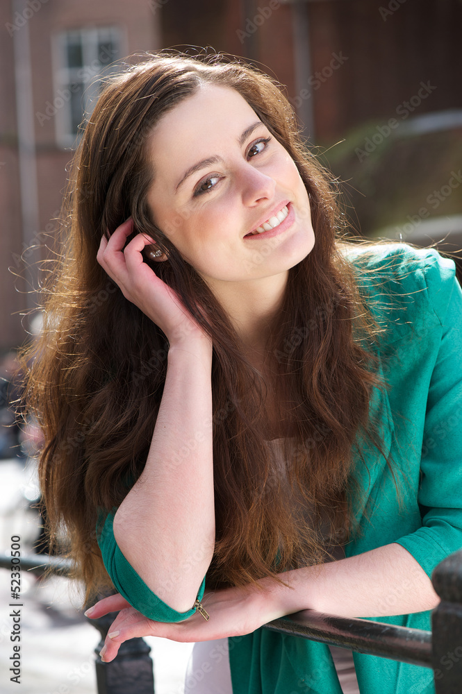 Fototapeta premium Portrat of a friendly young woman looking at camera