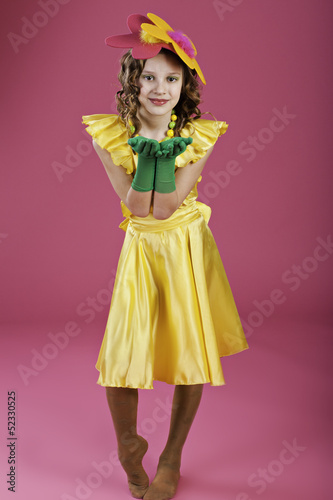 girl with flower on her head and in a yellow dress