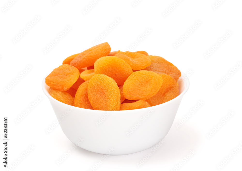 dried apricots in a bowl on white