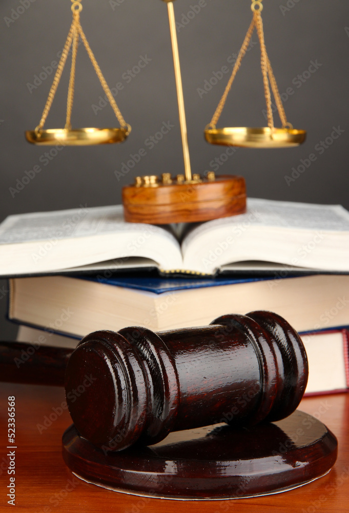Wooden gavel, golden scales of justice and books Wooden gavel, golden scales of justice and books