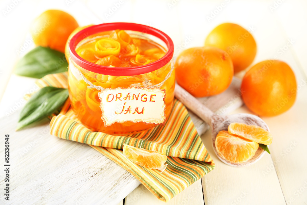 Orange jam with zest and tangerines, on white wooden table Orange jam with zest and tangerines, on white wooden table