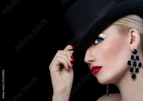 Beautiful girl in black hat with red lipstick