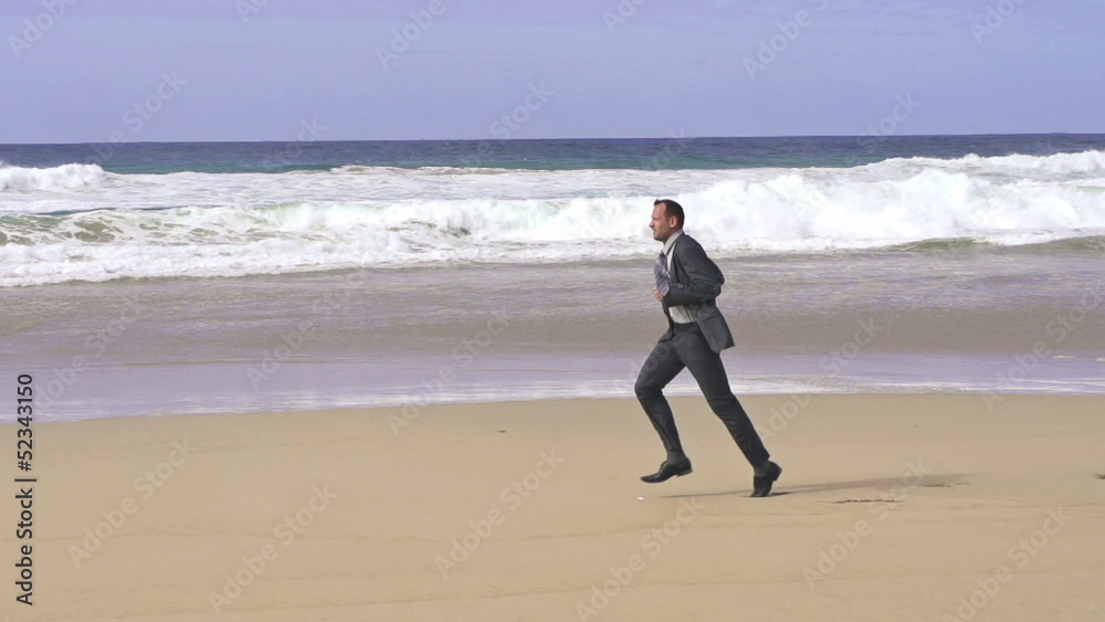 Businessman jogging on the beach, super slow motion, shot at 240 Businessman jogging on the beach, super slow motion, shot at 240