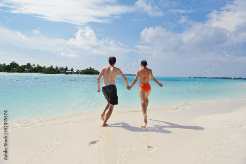 happy young couple have fun on beach