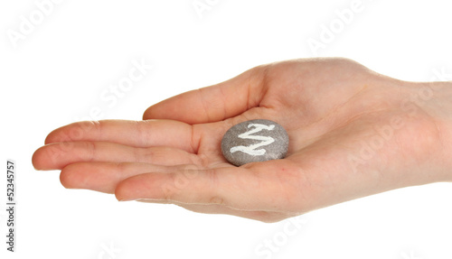 Fortune telling with symbols on stone in hand isolated on