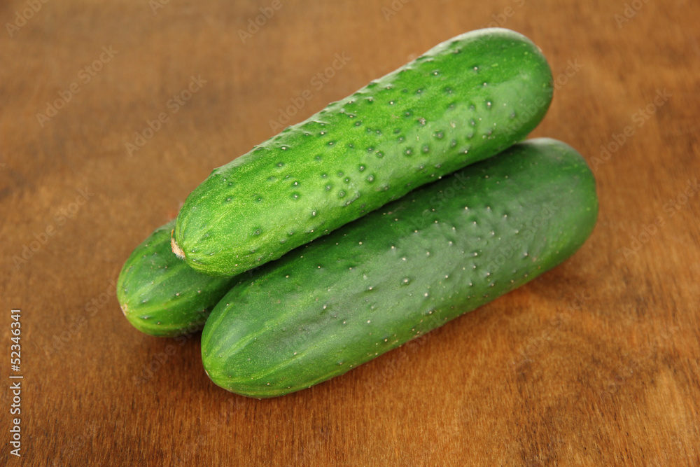 Tasty green cucumbers on wooden background Tasty green cucumbers on wooden background