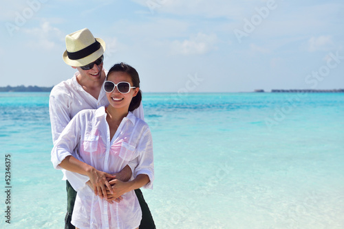 happy young couple have fun on beach