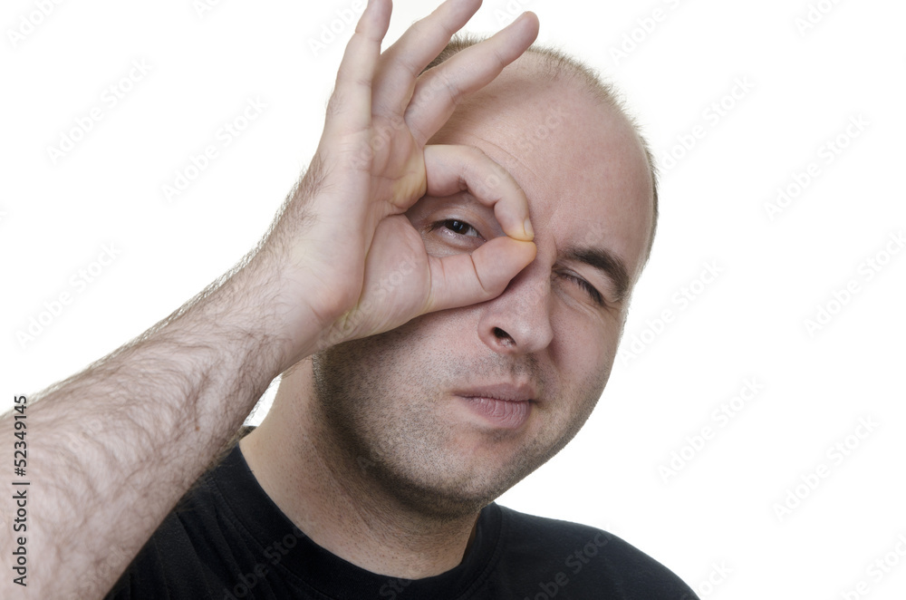 young man looking through fingers on white background young man looking through fingers on white background