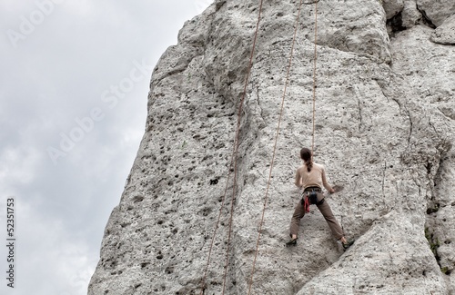 Young man climbing on limestone wall