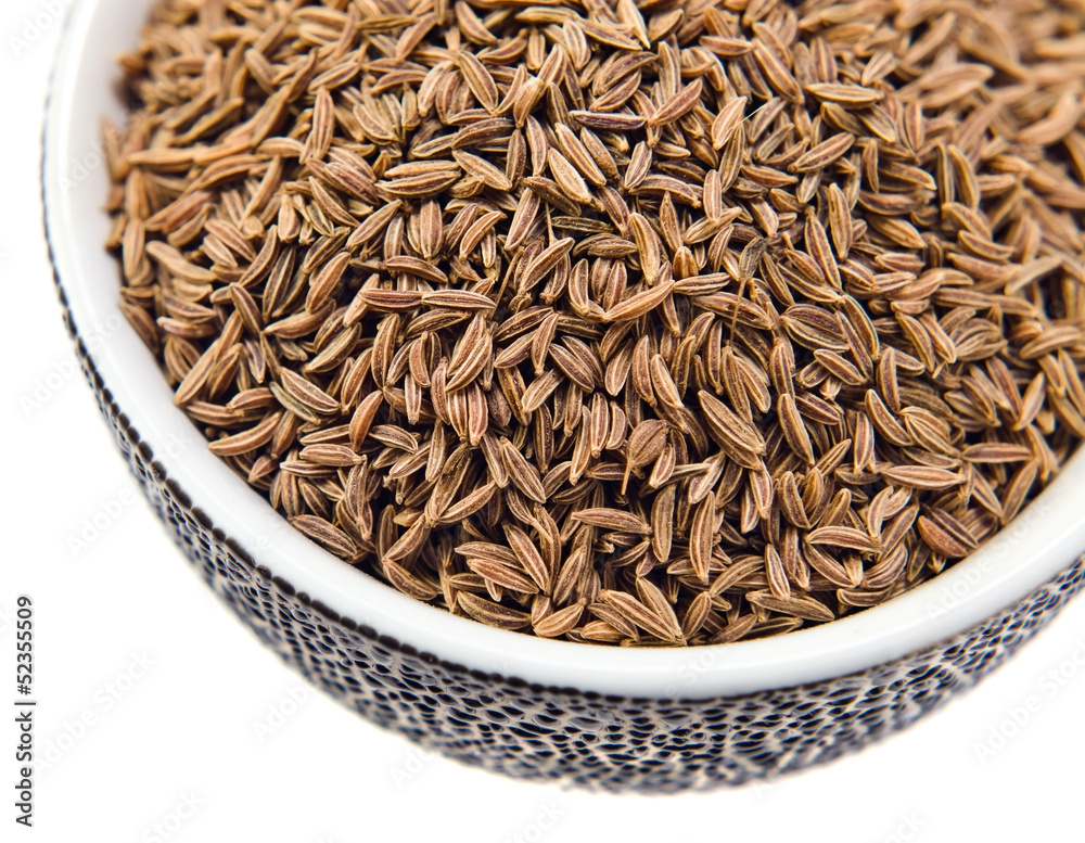Caraway seeds in a small ceramic cup