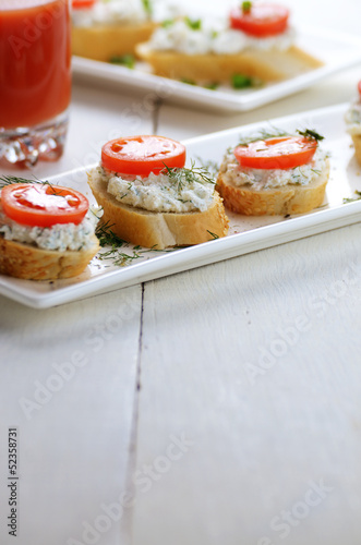 Breakfast of cottage cheese bruschettas and tomato juice