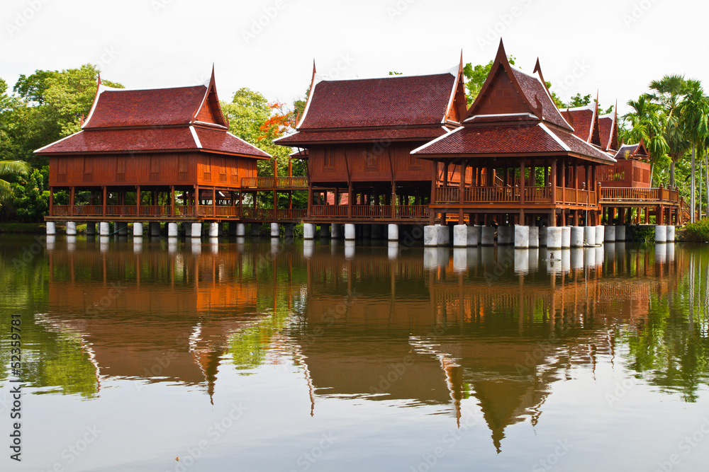 Thai style house and reflection in the water Thai style house and reflection in the water