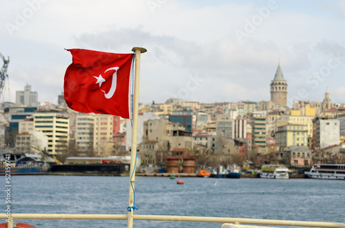 Canvas Print Galata tower with waving turkish flag