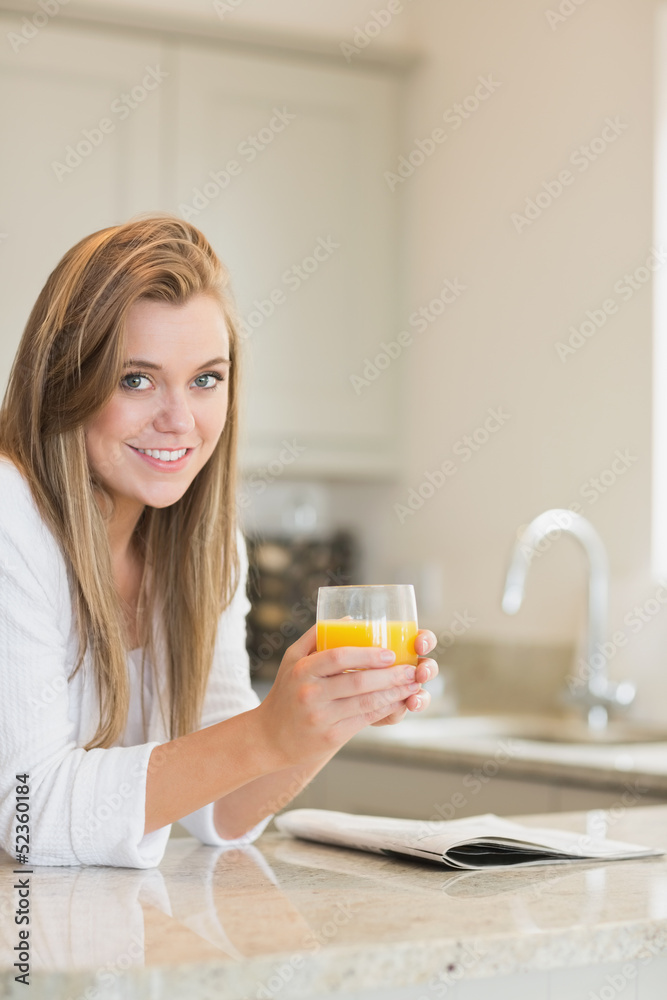 Woman reading while drinking orange juice Woman reading while drinking orange juice