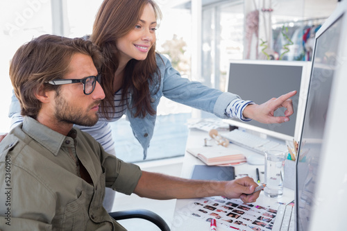 Colleague pointing photo out to editor