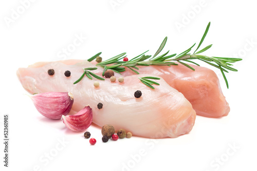 Raw chicken breasts with pepper, garlick and rosemary isolated o photo