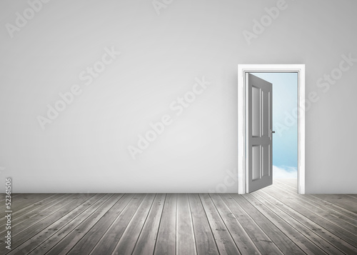 Doorway opening to blue sky in grey room
