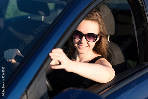 Beautiful businesswoman in sunglasses driving in the car © len44ik