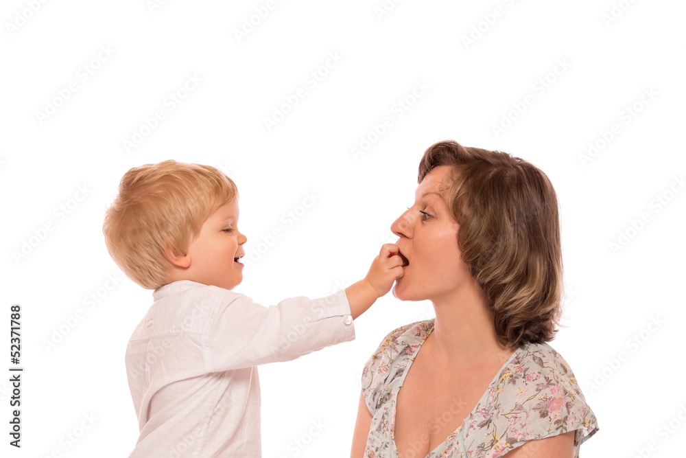 Young boy giving a candy to her mother Young boy giving a candy to her mother