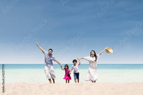 Happy family running at beach