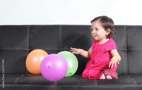 Baby happy playing with balloons