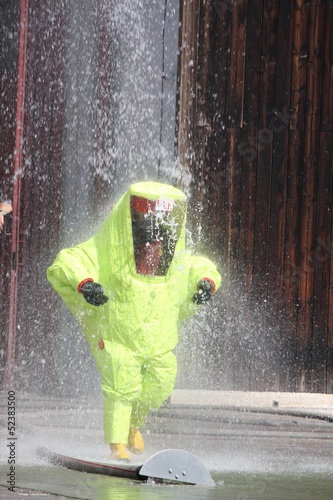 Fireman with a suit for protection in the midst of malicious foa photo