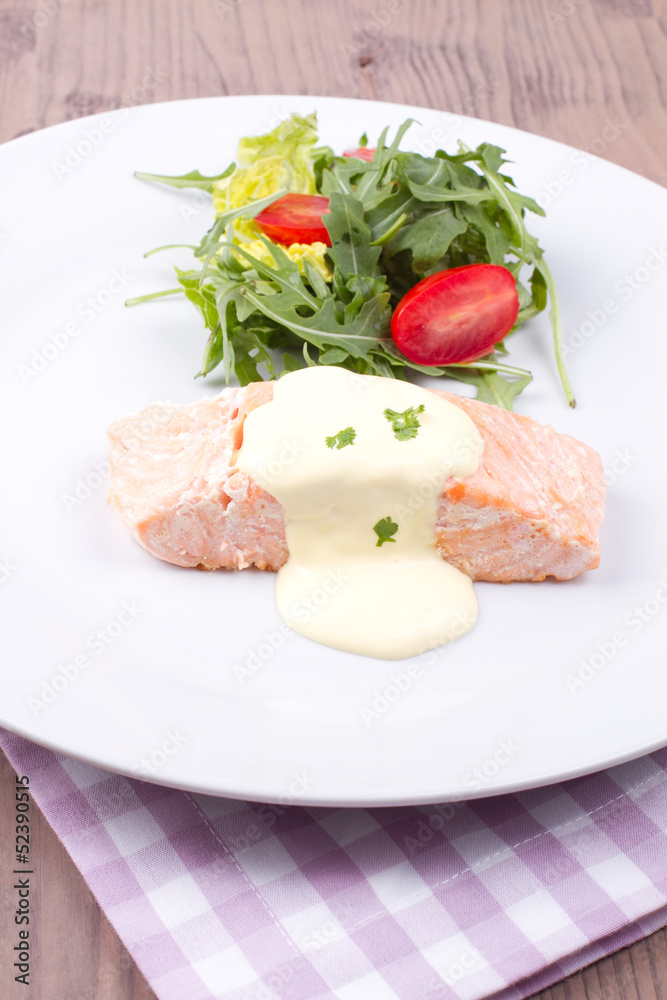 Salmon with hollandaise sauce and salad