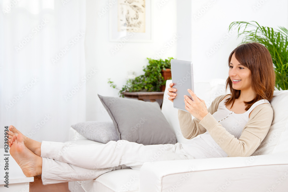 Young woman working with a digital tablet at home Young woman working with a digital tablet at home
