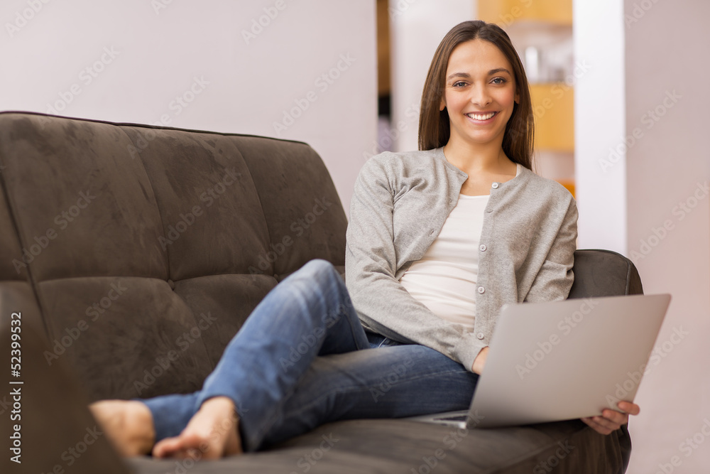 Relaxed woman on sofa with her laptop Relaxed woman on sofa with her laptop
