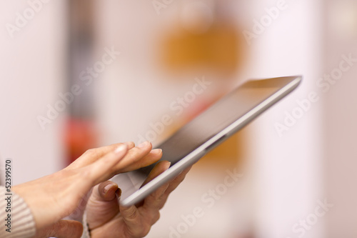 Woman hand touching screen on digital tablet.
