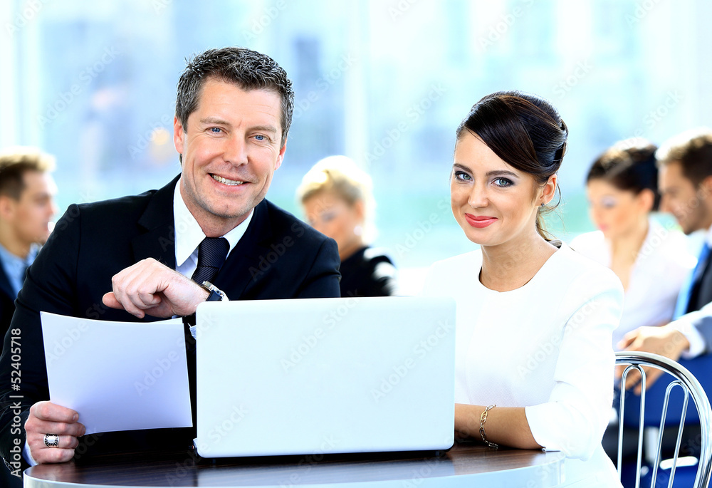 Businessmen and businesswoman discussing tasks sitting Businessmen and businesswoman discussing tasks sitting