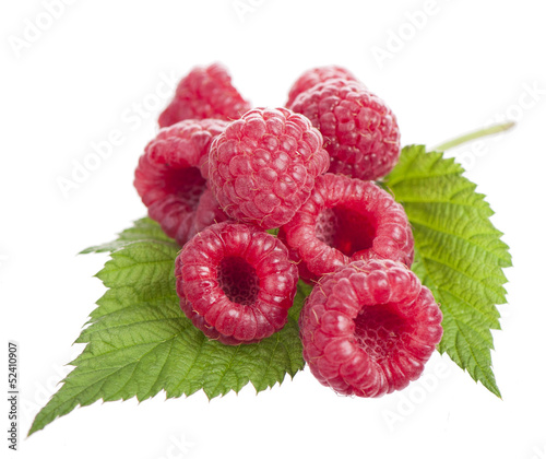 Ripe raspberry with green leaf on white background