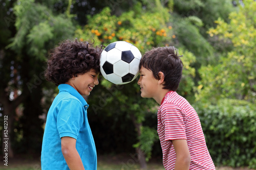 Two young boys playng with a soccer ball © Nicholas B