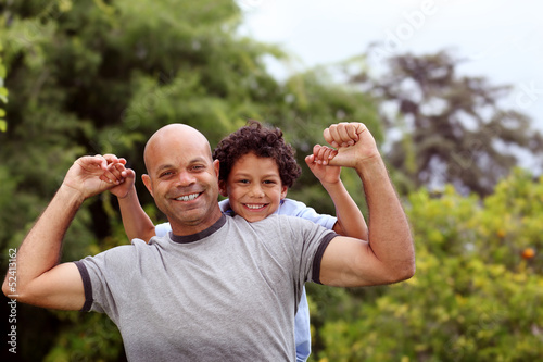Mixed race father and son playing in the back garden