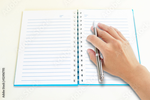 hand on notebook