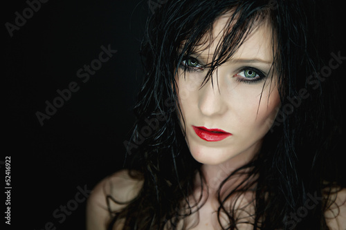 Portrait of a bautiful young woman with red lipstick an wet hair