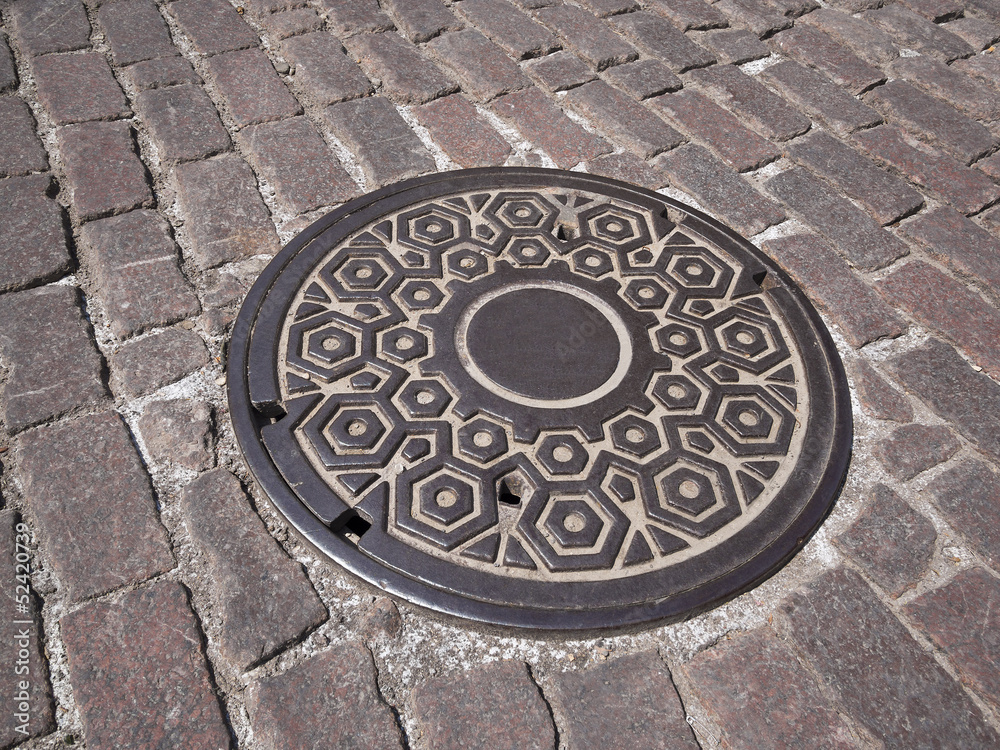 Manhole cover on old  street