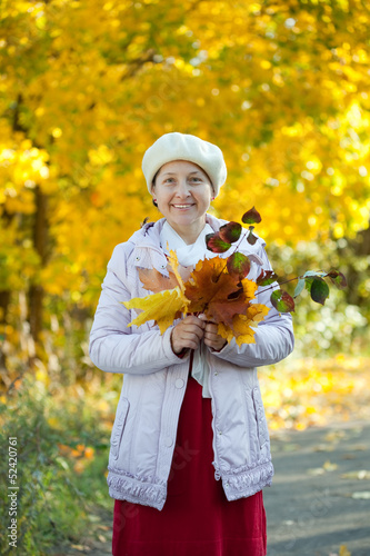  happy mature woman  in autumn park