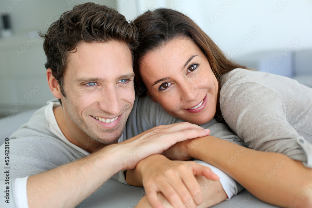 Portrait of sweet couple sitting in sofa Portrait of sweet couple sitting in sofa