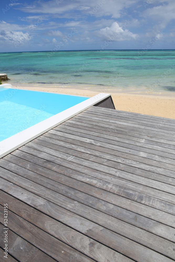 Beautiful view of infinity pool with wooden deck